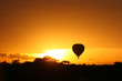 Hot air balloon flying at sunrise over Masai Mara Park, Kenya Hot air balloon flying at sunrise over Masai Mara Park, Kenya