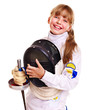 Child in fencing costume holding epee .