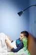 Kid reading a book at bedtime