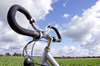 Bicycle handlebar on cloudy sky. No fuel needed