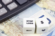 Canadian currency with calculator and dice showing STOP LOSS