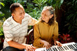 ethnic old mother and son happy playing piano together ethnic old mother and son happy playing piano together