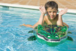 Kid playing at the swimming pool