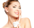 Foto: Beautiful spa girl holding jar of cream isolated on white Beautiful spa girl holding jar of cream isolated on white