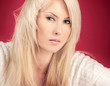 Portrait of beautiful young woman against red background