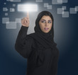 arabian businesswoman pressing a touchscreen button with hijab