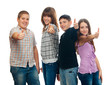Group of happy teenage friends holding thumbs up
