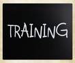 "Training" handwritten with white chalk on a blackboard