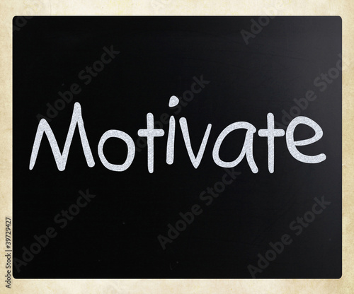 Illustration: "Motivate" handwritten with white chalk on a blackboard "Motivate" handwritten with white chalk on a blackboard