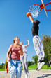Teenagers playing basketball