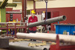 Photo: Machinist moving a steel tube Machinist moving a steel tube