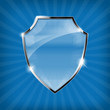 Glossy security shield on blue background - vector
