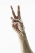 Foto: Hand with two fingers up in the peace or victory symbol. Also th Hand with two fingers up in the peace or victory symbol. Also th