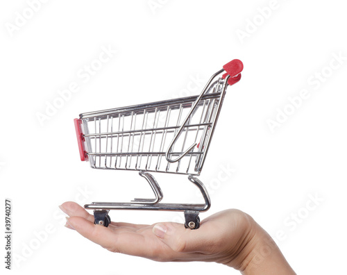 Photo: The shopping cart isolated on white background The shopping cart isolated on white background