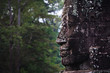 Stone face and jungle at Angkor Wat Stone face and jungle at Angkor Wat