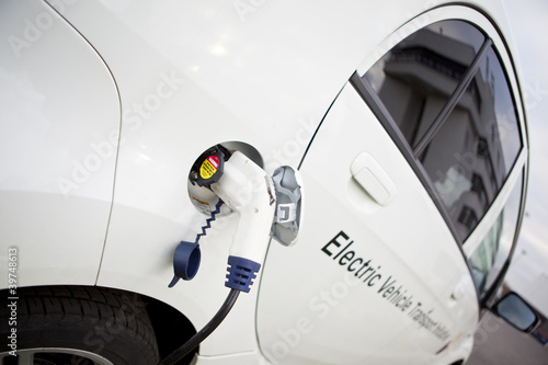 Photo: White Electric Car Charging Outdoor White Electric Car Charging Outdoor