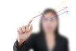 Business lady pushing up graph on the whiteboard.