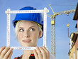 Beautiful young worker with yardstick in front of building lot