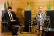 Photo: business man and business woman waiting in office lobby business man and business woman waiting in office lobby