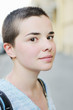 Outdoors portrait of bald young woman
