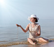 Photo: Woman in white hat posing against the sea Woman in white hat posing against the sea