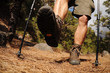 Hiking man with trekking boots on the trail