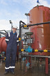 Petrochemical contractor posingl in front of an oil refinery