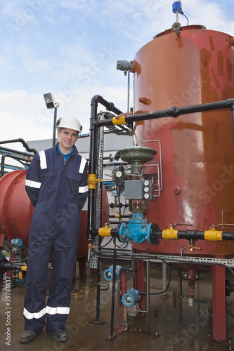 Photo: Petrochemical contractor posingl in front of an oil refinery Petrochemical contractor posingl in front of an oil refinery