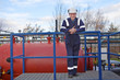 Petrochemical contractor posingl in front of an oil refinery