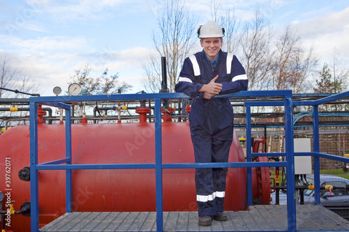 Photo: Petrochemical contractor posingl in front of an oil refinery Petrochemical contractor posingl in front of an oil refinery