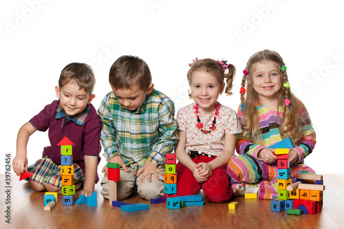 Photo: Four children are playing on the floor Four children are playing on the floor