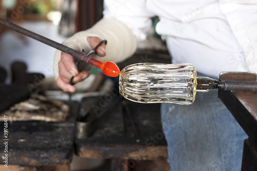 Photo: Glass blower shaping molten glass Glass blower shaping molten glass