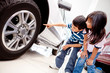 Kids looking at car wheels