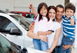 Family with keys of new car