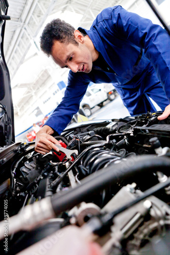Photo: Man fixing a car Man fixing a car