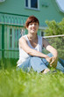 Happy woman on lawn in front of home Happy woman on lawn in front of home