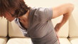 Woman having a back pain.