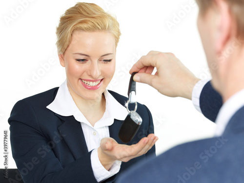 Photo: Pretty young woman gets the key of her new car Pretty young woman gets the key of her new car