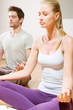 couple sitting on floor doing yoga