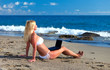Sexy beautiful woman in bikini using laptop at the beach