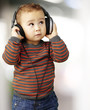 portrait of a handsome kid listening to music looking up indoor portrait of a handsome kid listening to music looking up indoor