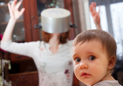Photo: Scared baby against crazy mother Scared baby against crazy mother
