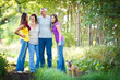 Family portrait - Family of four with a cute dog outdoors