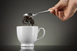 tea pour out into white cup on grey