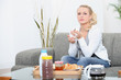 Woman sat at home eating breakfast