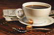 Coffee cup and newspaper. Focus on handle of cup Coffee cup and newspaper. Focus on handle of cup