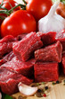 Raw beef on cutting board and vegetables
