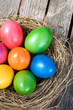 Photo: Easter eggs in nest on a wooden table Easter eggs in nest on a wooden table