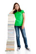 Student standing close to pile of books on white