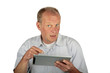 Surprised man pointing to his tablet computer